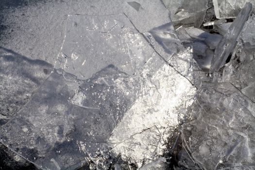 Brocken ice shinning in the winter sun and reflecting the blue sky.