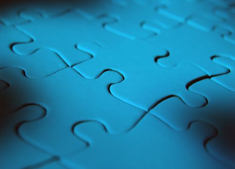 Blue coloured jigsaw puzzle with plain pieces