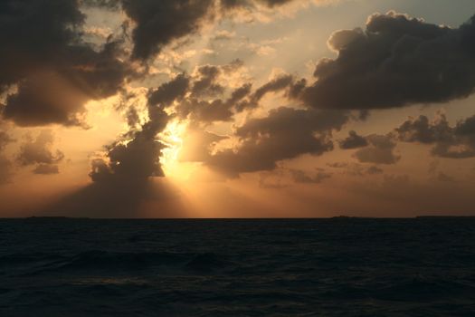 A dramatic sunset and the light and shadows from the clouds.