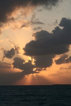 A dramatic sunset and the light and shadows from the clouds.