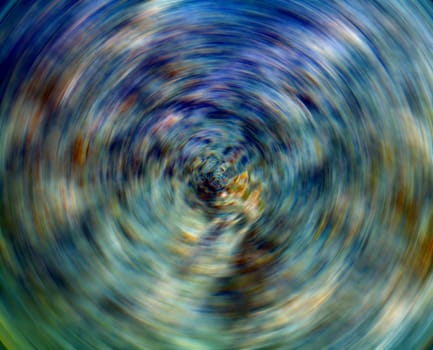 An abstract image of spinning blue and green colors.