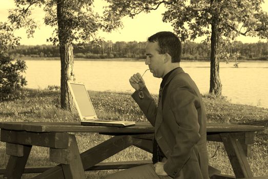 A young man working on a laptop, shot in Sepia