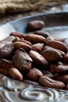 Cocoa (cacao) beans on iron dish, close-up