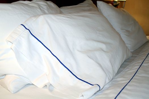 Clean white linens on a hotel bed and pillow
