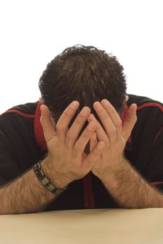 Depressed man who is devastated at hearing some recent news has his hands over his face