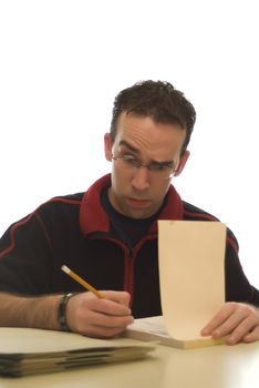 Young adult male doing his work at home and making a funny expression