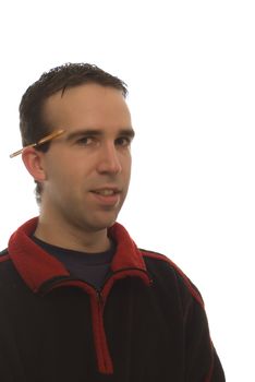 A young man's portrait with a pencil behind his ear and wearing a black sweatshirt with red trim isolated against a white background