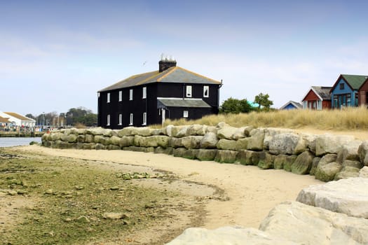A black house located near Muddeford, a small harbour inlet with adjasent wooden beach huts. Located in Christchurch, Dorset Hampshire UK.
