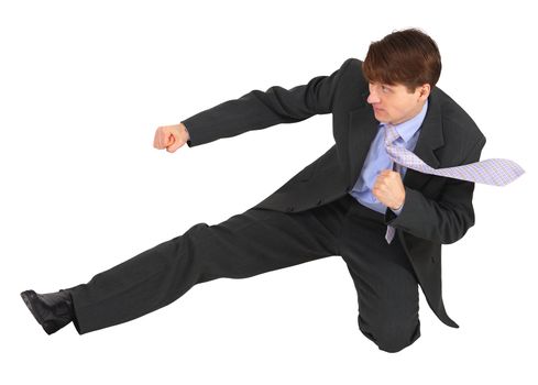 Businessman kicks forward, isolated on a white background