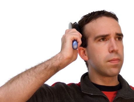 Young metrosexual man brushing his hair, isolated against a white background
