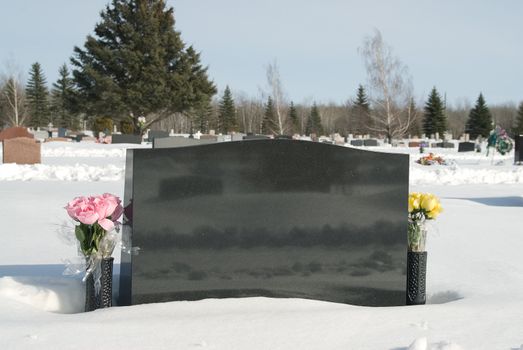 A graveyard in the middle of winter, with snow on the ground