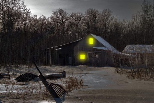 An old house in the middle of winter with snow on the ground and junk in the yard