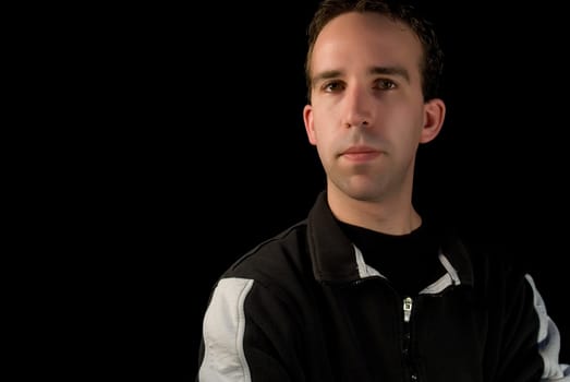 A young man's portrait isolated against a black background