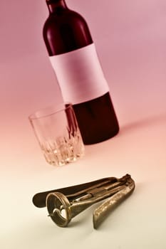 Wine bottle and metal corkscrew with bicolor graduated filter