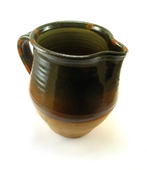 a brown and green jug on a white background