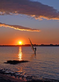  windsurfer speeding fast against the sunset