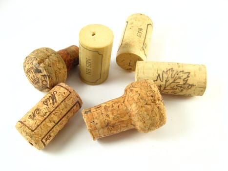 some corks of wine bottles over a white background