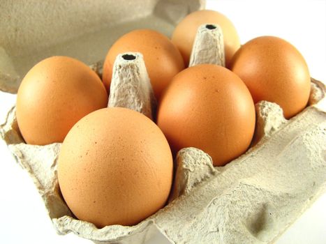 close-up of eggs box over a white background
