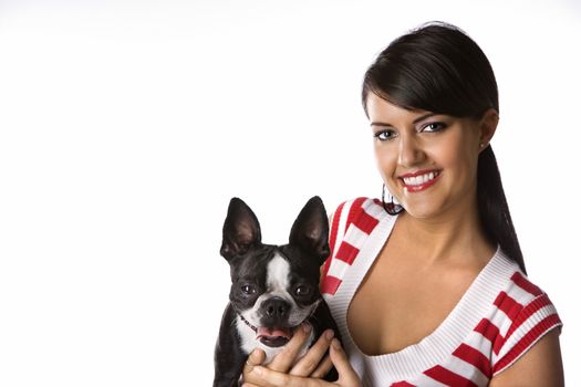 Young adult female Caucasian holding Boston Terrier dog.