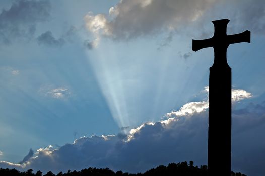 cross silhouette in heaven blue sky