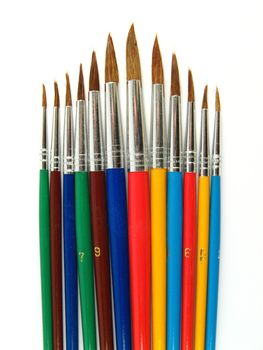 Some colored paintbrushes on a white background