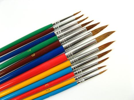 Some colored paintbrushes on a white background