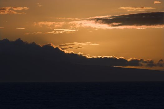 Sunset over Pacific Ocean with clouds in Maui, Hawaii, USA.