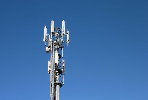 Closeup of transmitter tower against cloudless blue sky