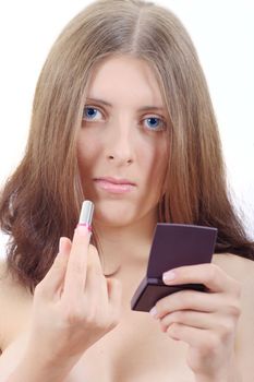 The nice girl with lipstick and a mirror doing a make-up