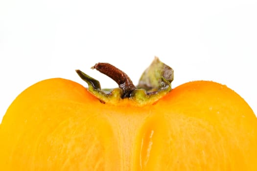 Half of the cut persimmon removed close up on white background without isolation