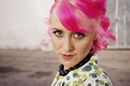 Woman with pink hair in an alley