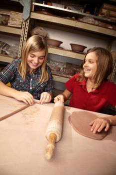 Cute young girls working on projects in a clay studio