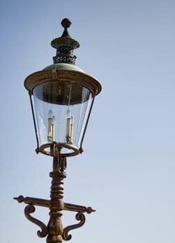 detailed antique lamppost with blue sky background