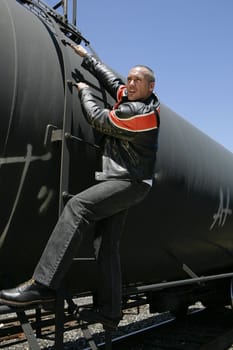 Male fashion model posing on a train