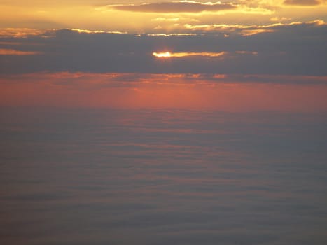 The sun rising above the clouds from the Blue Ridge Parkway.