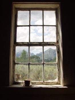 An old frontier ranch window with a tin cup.