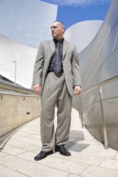 Male Model Posing as business man in front of high tech building
