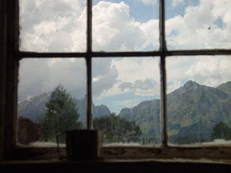 An old frontier ranch window with a tin cup.