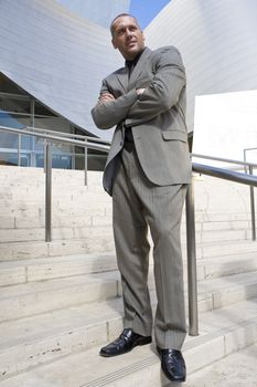 Male Model Posing as business man in front of high tech building
