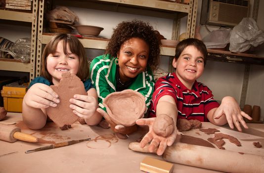 Teacher and young students having fun ion clay studio