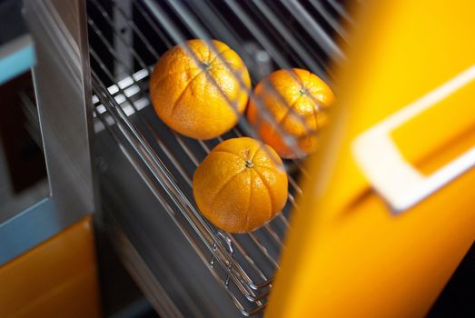 Tasty orange in kitchen in fridge