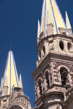 Yellow tiled steeples of cathedral in Guadalajara, Mexico
