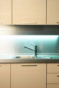 Modern stainless steel tap in white kitchen