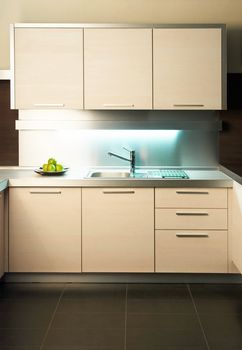 Modern stainless steel tap in white kitchen