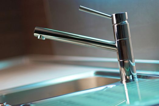 Modern stainless steel tap in white kitchen