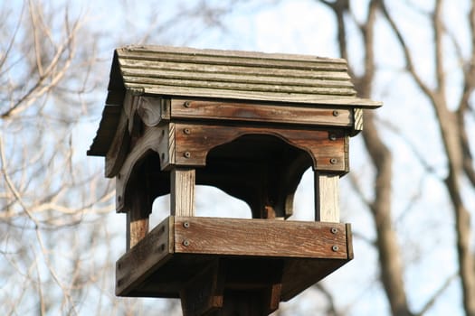 Close up of a bird house in a park.