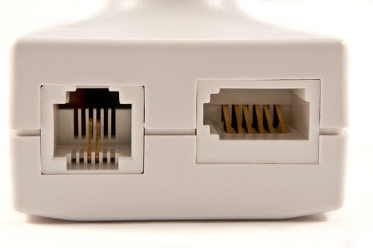 Close and low level of an isolated white broadband telephone filter arranged over white.