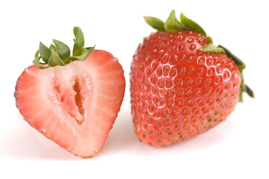 Close-up of a half and a whole strawberry 