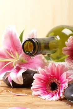 Bottle of massaging oil over spa background           