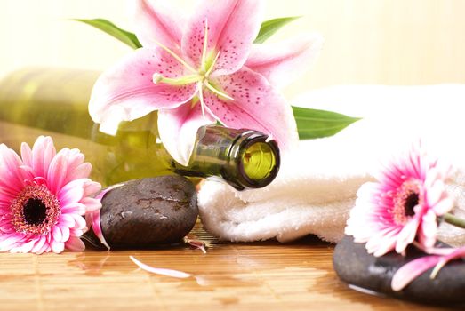 Bottle of massaging oil over spa background           